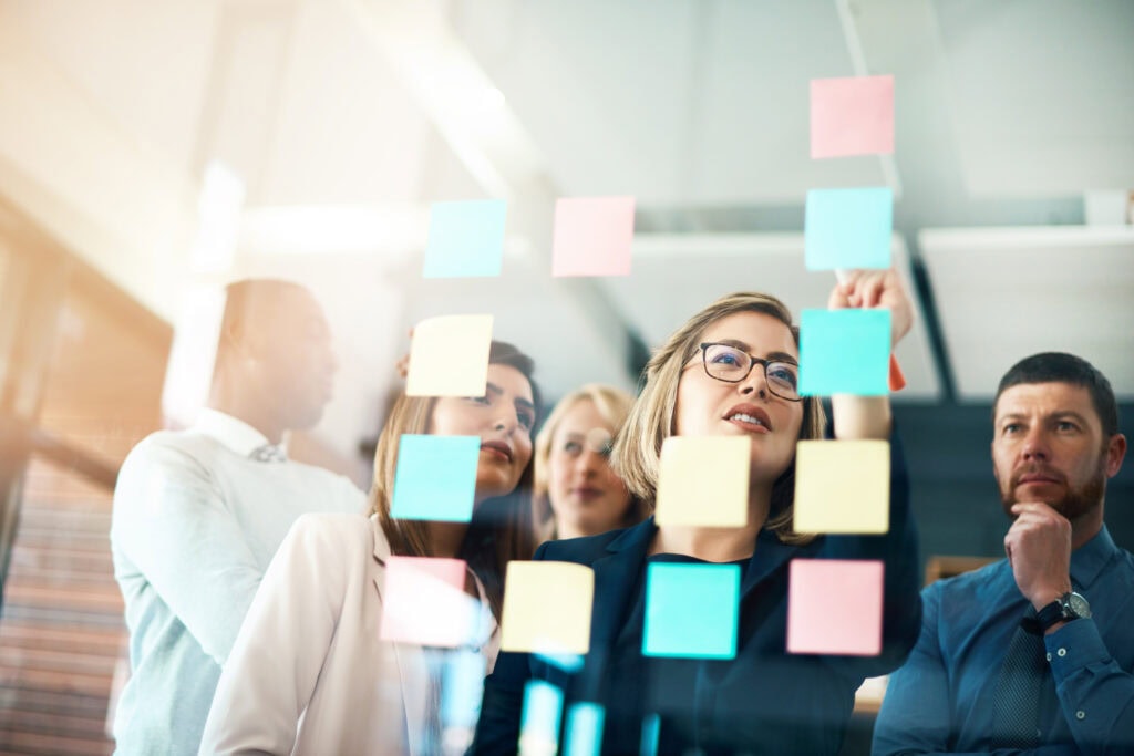 Business team brainstorming ideas using colorful sticky notes during project planning